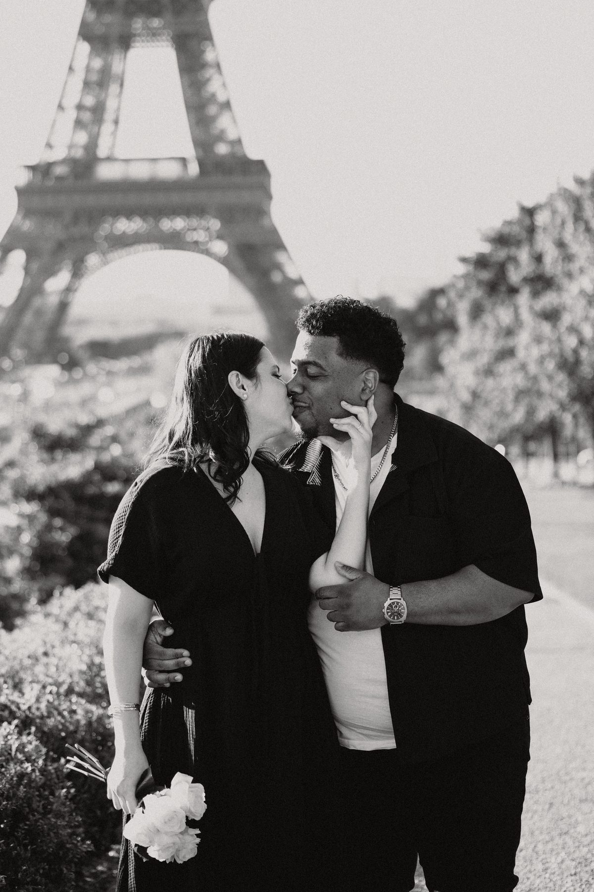 Paris proposal couple kissing near the Eiffel Tower